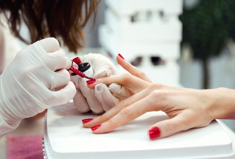 Young woman doing manicure in salon. Beauty concept.
