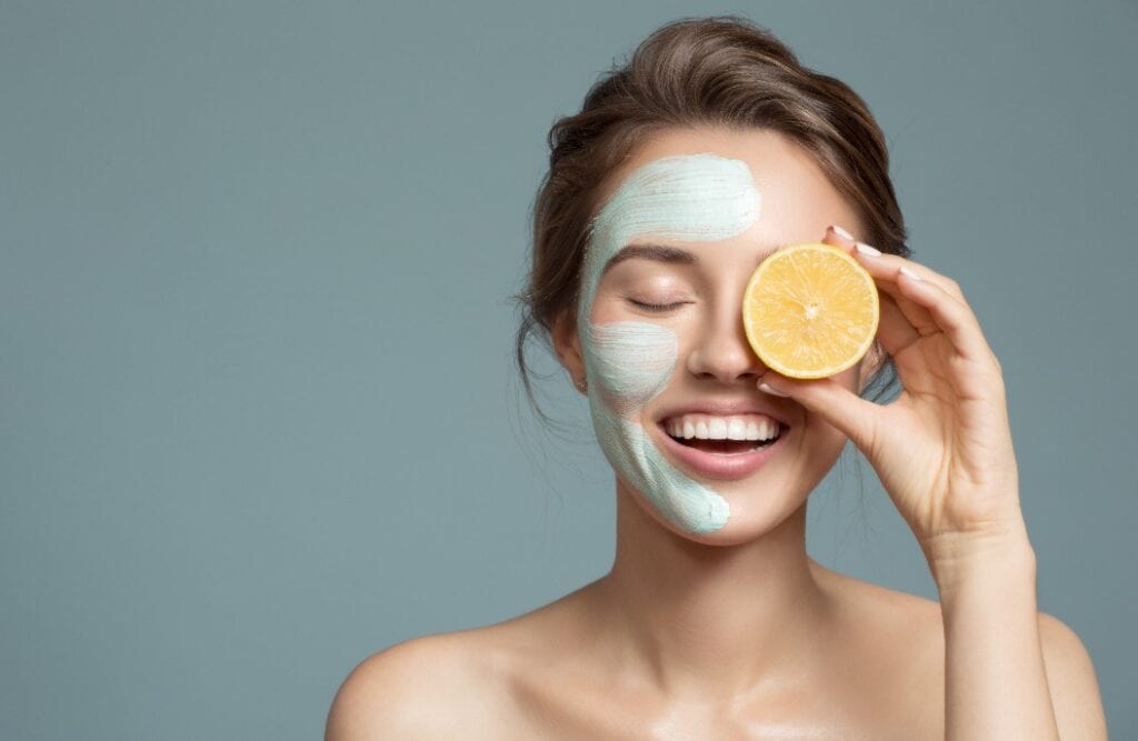 Portrait of beautiful woman with blue cream mask on her face.